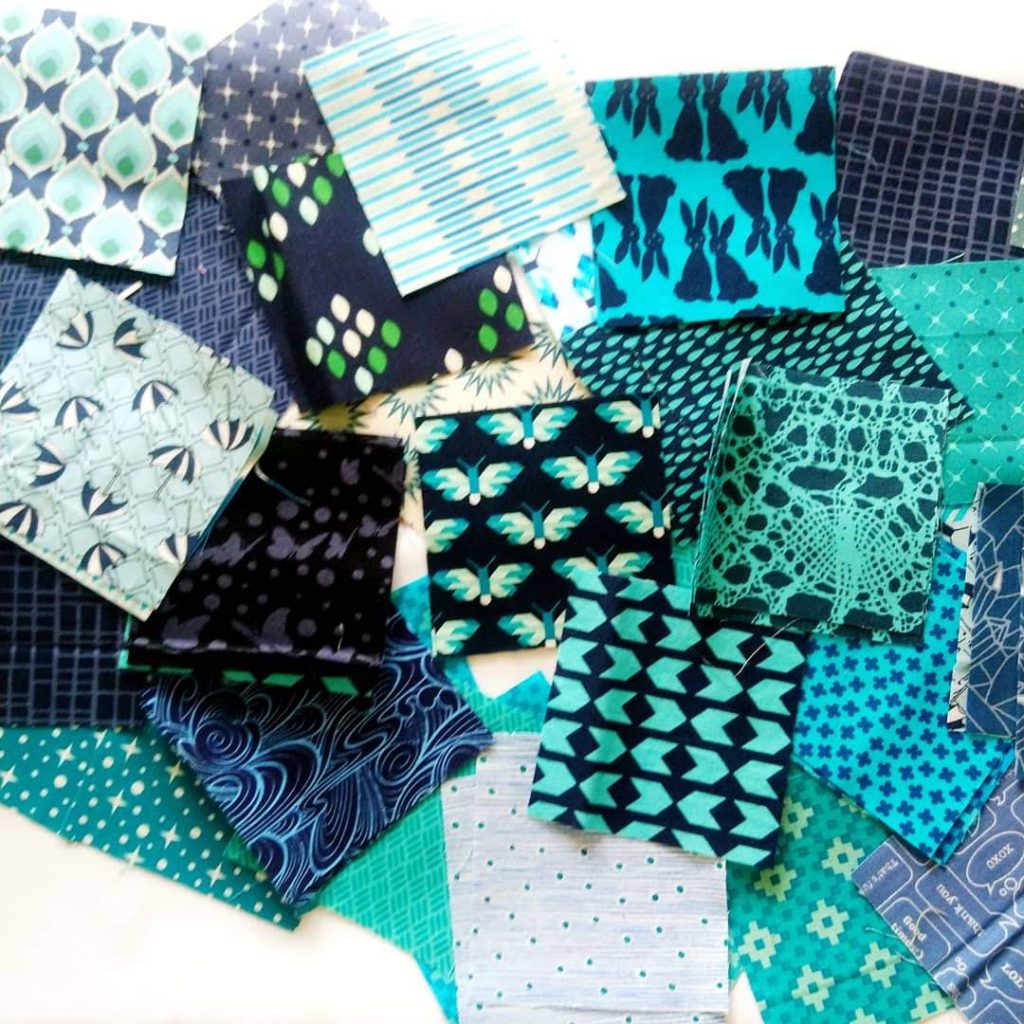 Randomly placed fabric swatches in varying shades of blues and greens.