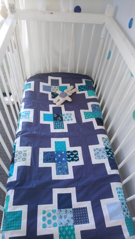 Hugo Room Reveal cot with quilt tucked in 