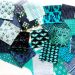 Randomly arranged fabric swatches in varying shades of blues and greens.