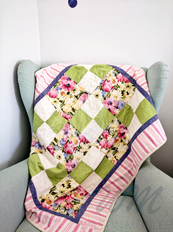 First quilt draped on mint green chair